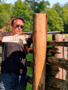 Finally, Pete uses a STIHL chainsaw to cut off the excess wood at the top, so both posts are level.