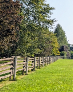 Guests always admire these fences. They love the antique style and the well weathered and aged surfaces. The railings are sandwiched between two cedar posts buried deep into the ground.