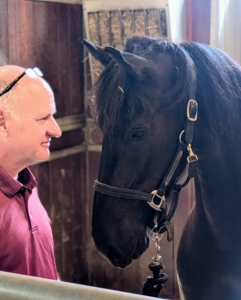 The key to working with horses is to gain their trust, which in turn helps them calm down. Brian spends a few minutes just talking to Ulysses before he begins working.