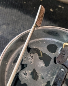 Each float is fitted with a sharp tungsten carbide blade made of chips that are bonded to the base. This is what files each tooth during the floating process. Brian has 10-floats in his bucket. The floats also come in varying angles for use on different teeth.
