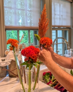 For this arrangement, Enma carefully selects a palette of bright orange celosias and coordinating amaranths. Whether you plant the plumed type with its striking upright spires or the crested type with its fascinating twisted form, celosia stands out in any room.