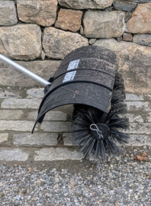 The brush head features durable nylon bristles and a wide sweeping surface that covers a two foot wide area as it moves.