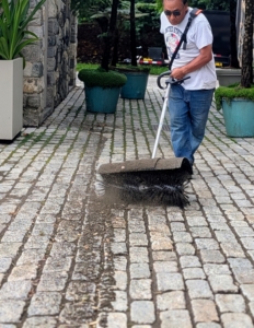 Pete goes from one end to the other in rows - the brush only removes the surface dirt and doesn't disturb any of the mortar between the cobblestones.