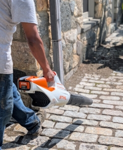 Next, Pete uses the STIHL battery-powered blower around the building and ornamental planters where the brush cannot reach.