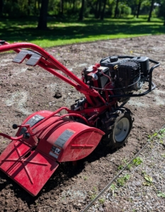 As Phurba moves, he makes sure to overlap his passes slightly, so every bit of soil is covered. Tilling also helps to level the ground as it turns over the soil.