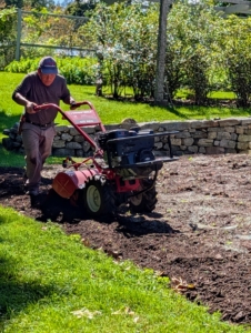 Rototilling is one method of turning up the soil before planting. It also helps to loosen any other root balls that may have been left deep in the bed. I always rototill the earth before planting a new garden.