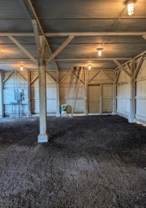 The dirt floor is raked level and cleaned of any small debris.