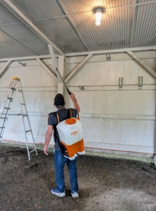 And then using a STIHL SGA 85 Cordless Backpack Sprayer, Fernando treats the walls with a dirt and mildew remover and then rinses it off thoroughly.