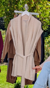 If you're looking for a perfect transition piece this season, get my Sleeveless Sweater Cardigan with Belt. It has a basketweave knit stitch with novelty sequin accents to give it just the right pop. And, it has deep pockets to carry essentials. Here it is in moon beam, but it also comes in a light Arona blue.