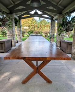 In 2021, after a large yew tree was removed from my former East Hampton home, I decided to give the wood a second life by turning it into this large dining table for the pavilion. I designed it to be three tables connected as one.