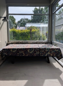 I store the table in a glass room next door to my Equipment Barn. The tables are carefully placed in the room and then covered for the season.
