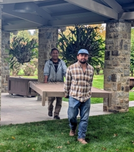 And then one by one, Jimmy and Pete carry the furniture to their storage space in the glass room.