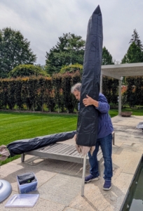Meanwhile, back at my pool, Fernando closes and covers all the shade umbrellas so they are ready for storage.