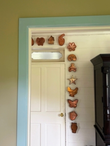 Copper cookie cutters featured in Martha by Mail are arranged around a doorway leading into the kitchen. It is a recreation inspired by the photography in my Martha by Mail catalog.
