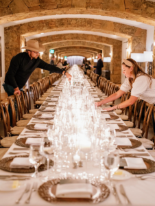 Brian also says his career in events planning was inspired by my lessons, tips, and ideas. Here he is with a colleague lighting candles for a rehearsal dinner for 100 at Brush Creek Ranch’s wine cellar in Saratoga, Wyoming.