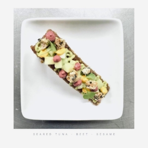 This is seared tuna and beets, on sesame bread. Jordan adds, "When I'm cooking for a family on a yacht or in a villa, the standard I hold for myself is hers: to do it properly, use what's good, make it beautiful without making a fuss."