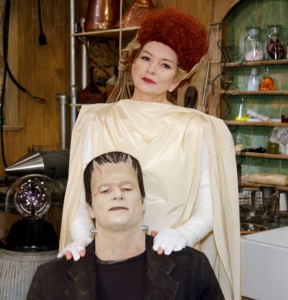 Remember some of these following great costumes? Meet my dear husband, Frank. He’s the strong, silent type. We’re pictured in our well-appointed potting shed turned laboratory, surrounded by some of our most useful possessions – test tubes, newt brains and electrodes.