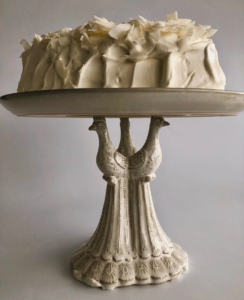 He often serves it on this peacock cake stand.