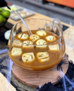 The apples are skinned, cored and then carved - one can use a melon baller and chop stick to carve a face into the flesh of the apple. Add a clove in each eye socket for an even scarier look.