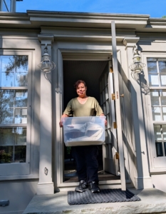 Occasionally, I redecorate my homes with items I already have. My housekeeper, Elvira Rojas, carefully moves a collection of pottery from one building to another.