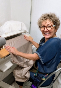 Sheets are ironed on a mangle, a mechanical device that was designed to apply even pressure to fabrics in order to smooth out wrinkles. Pati irons as soon as the sheets are ready.