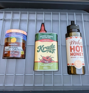 Here are three cooking ingredients - Krude Chilli Oil, Momofuku Chili Oil, and Mike’s Hot Honey.