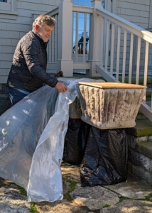 Meanwhile, Fernando places plastic under and on top of these planters outside my Winter House kitchen.