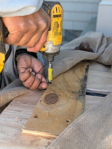 Once plywood is cut and fit on top, Pete also connects both pieces with another cut of wood, so they do not move.