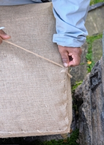And then the sewing can begin. Pete wraps two together, tucking and pulling to keep it all tight and tidy.