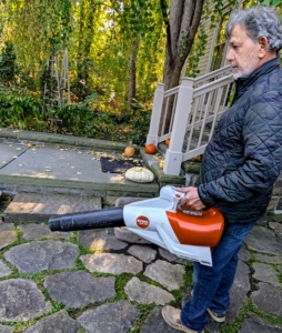 Meanwhile, Fernando uses my battery powered handheld blower from STIHL to blow any leaves from the area.