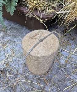 To sew burlap, the crew uses jute twine. It is all natural and the same color as the burlap. Five-inch long needles specially designed for sewing this material have large eyes and bent tips. Every member of my outdoor grounds crew has a needle. Pete stitches the top of the fabric together pulling the burlap snug.