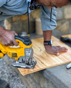 And then carefully cuts the plywood to size.