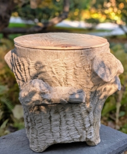 It's perfect. The wood top fits right over the pot's hole resting on the edges of the container.