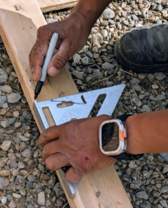 Using a set square ruler, Pete makes the appropriate marks for cutting.