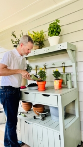 In gardening, Jake has been enjoying autumn planting. His potting bench, painted a soft Martha-inspired green, holds a collection of original Martha Stewart Everyday gardening tools. Two smaller, bright orange Martha Stewart Everyday pots filled with yellow mums add a splash of fall color. These are the sorts of pieces that make even an ordinary afternoon of gardening feel special.